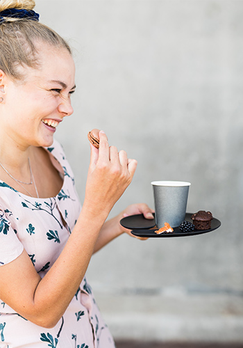 Girl having fun while holding a plate with glass holder