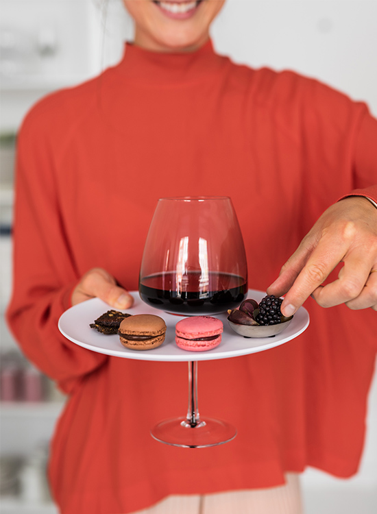 Woman holding a party plate with glass holder